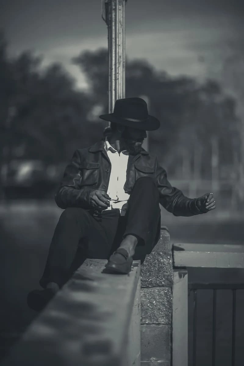 Black and white portrait, seated on a ledge